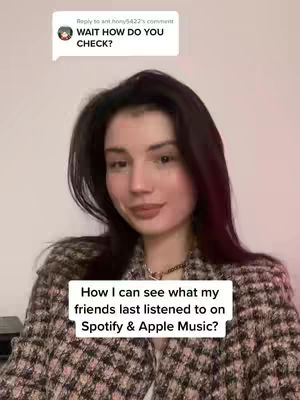 A woman with dark hair and a plaid jacket is centered in the image. A text overlay at the bottom states, "How I can see what my friends last listened to on Spotify & Apple Music?" and there's a comment bubble in the top left corner that says: "WAIT HOW DO YOU CHECK?"