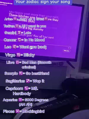 The cover image shows a television screen displaying a list of zodiac signs, each paired with a song title. The screen has a purple hue and the text is written in a sans-serif font. The bottom of the image shows part of a remote which implies that the image was taken with a phone.