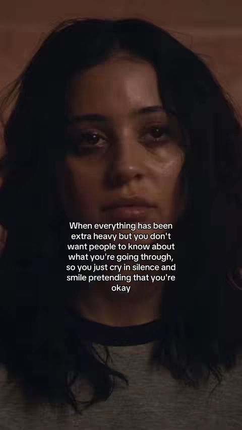 The cover image is a close-up shot of a person's face, likely a young woman, with dark hair. Her complexion is fair, and her expression appears sad, with visible tears in her eyes. The background is blurred, suggesting a shallow depth of field, which draws focus to her face. Text overlayed on the image reads a message about hiding emotions.