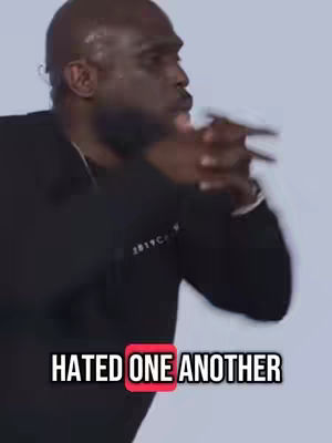 A man with a shaved head and black top is the primary focus, with a neutral background. Text overlayed at the bottom reads, "HATED ONE ANOTHER," with the word "ONE" highlighted in a red box. The man's hands are clasped, and he has a focused expression.