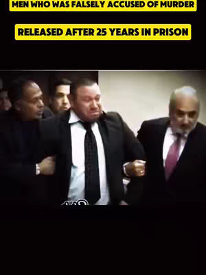 The cover image is a vertical shot featuring a group of men in suits, likely in a courtroom setting. The central figure, dressed in a dark suit with a light-colored shirt and dark tie, has a somewhat distressed expression and is being supported by two men on their left, one of whom is holding their arm. Another man in a suit is on their right. Above the image, there's a black background with yellow text that reads, 'MEN WHO WAS FALSELY ACCUSED OF MURDER' and 'RELEASED AFTER 25 YEARS IN PRISON'. The image has a somber tone, likely depicting a serious or emotional moment.
