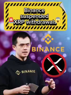 A video cover image featuring a man in a black hoodie with the Binance logo, in front of a blurred background. A yellow banner at the top reads "Binance suspended XRP withdrawals" with graphic elements. A large red circle containing a line through the XRP symbol is on the right.