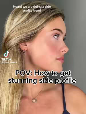 A woman with blonde hair is featured in a close-up, angled to show her profile. She has light skin, and is looking up and to the right. Text overlays include the TikTok logo and username, a statement about a side profile trend, and a prompt to viewers.
