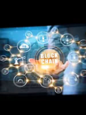 The image shows a person's hand holding a glowing orb with the text 'BLOCK CHAIN' in the center, surrounded by interconnected icons representing various technological elements. The background has a bluish glow with interconnected nodes forming a network. The overall composition suggests a futuristic tech theme, likely related to cryptocurrency or blockchain technology.