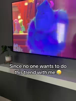 A cover image shows a television screen displaying a scene from the movie "Monsters, Inc.", with Sully and another monster on screen. The TV sits on a white shelf against a gray wall. Text is added to the image below the TV.