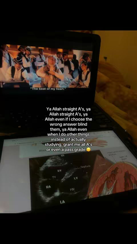 A laptop displaying a scene from a movie, with a second screen showing an ultrasound image and overlaid text. The laptop is angled down, and the overall tone is casual and relatable.