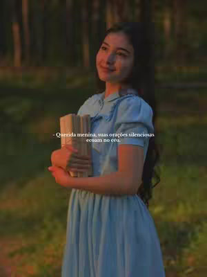 A serene image of a young woman standing outdoors, holding a stack of books. She is dressed in a light blue dress and appears to be looking towards the right with a peaceful expression. The background suggests a natural setting with trees and soft, diffused lighting.