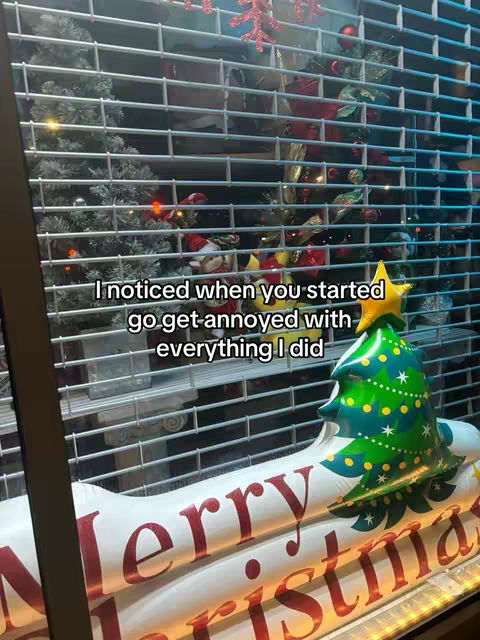 The image shows a scene behind a security gate, a Christmas tree decoration is in the background. The text overlay reads: 'I noticed when you started go get annoyed with everything I did.'