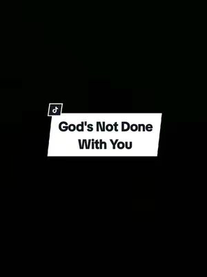 A minimalist graphic with a black background. A white banner with curved edges is positioned diagonally across the lower portion of the image. The text, 'God's Not Done With You,' is displayed in a bold, sans-serif font, centered within the banner. A small TikTok icon is in the upper left corner.