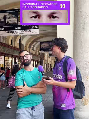 Two men are standing outdoors with one interviewing the other with a purple mic. There's text over them that contains eyes and text.