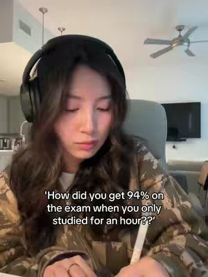 A woman in a camo jacket and headphones is looking down while writing on a pad. Text is overlaid on the image.
