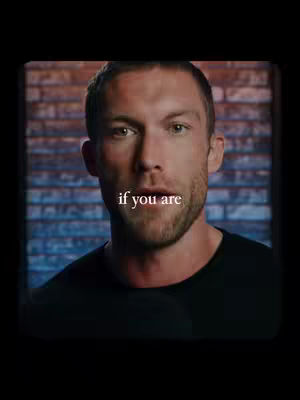 A man with a short beard and dark hair looks directly at the camera. Text overlays the image.