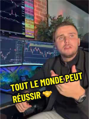 A man in a black jacket is seated, with charts on monitors behind him. The image has overlaid text in a yellow box near the bottom, encouraging viewers to believe in themselves and showing a handshake.