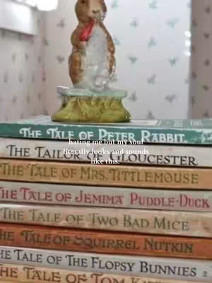 The image shows a stack of classic children's books, with a delicate ceramic figurine of a Peter Rabbit-like character perched on top. The books’ spines face forward, displaying their titles in elegant fonts against a backdrop of a light-colored, patterned wall. Additional text overlays the books, providing a humorous or reflective statement about the books’ contents.