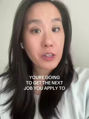 A woman with long dark hair is centered in the frame, gazing towards the camera while speaking. The background is a plain, light-colored wall. Text overlayed on the image reads, 'YOURE GOING TO GET THE NEXT JOB YOU APPLY TO.'