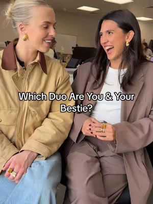 Two women are shown, close together. One is wearing a tan jacket and blue jeans, and the other a brown blazer and white top. The women are facing each other, both with a smile, creating a friendly and inviting atmosphere.