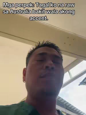 The cover image presents a medium shot of a man's face, seemingly taken from a low angle with a ceiling light in the background. The man is looking slightly upward, with his eyes closed. The text overlay is white against the image background, presumably explaining why the guy doesn't have an accent even though he's been in Australia for a while.