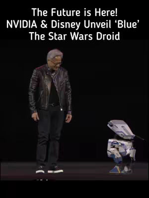 The cover image shows a man and a robot on a stage with a black background. The man, wearing a black leather jacket, black shirt, and black pants, is looking down at the robot on his right. The robot is white and blue and designed to look like a Star Wars droid. Text overlay at the top announces the subject.