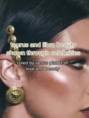 The image is a close-up shot of a woman's face. The text overlay reads \"taurus and libra beauty shown through celebrities ruled by venus planet of love and beauty\". She has dark hair, and a large, ornate gold earring with a circular design visible. The lighting highlights her face and the earring studs, bringing out the details and glow.