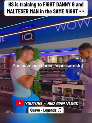 Two men inside a boxing ring. One is wearing boxing gloves and facing left, and the other is holding a blue pad for training. The text overlay indicates it is a boxing training session.