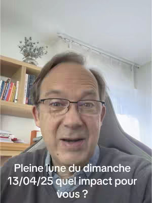 A man with glasses is centered in the frame, with text at the bottom. The background includes elements of a room: a bookshelf and a small plant detail. The color palette is muted, with emphasis on natural skin tones and cool neutral tones.