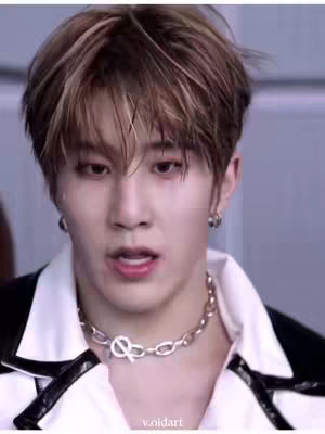 The cover image features a close-up of a young man, his face slightly turned to the side. He has brown hair with lighter highlights. He wears a white shirt under a black vest, and a silver chain. His expression is slightly open-mouthed, as if he's speaking, with a subtle look of surprise.