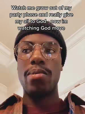 The cover image features a close-up shot of a young man with dark skin. He is wearing a black beanie and gold-rimmed glasses. The lighting appears to be natural, with soft shadows that define his facial features. Above him, the text in white font is overlayed.