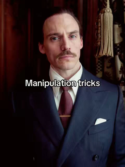 A man in a suit is the central focus, set against a backdrop of dark wood paneling and ornate drapes. The man, with a groomed mustache, direct gaze, and a white text overlay, is the subject of the image. The color scheme is dominated by dark blues, reds, and browns, creating a serious and composed atmosphere.