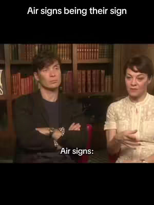 The image shows two people seated in a room with bookshelves in the background. The top of the image contains the text "Air signs being their sign". The bottom of the image contains the text "Air signs:". The people appear to be in a conversation.