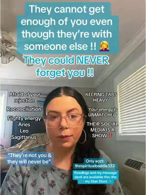 A woman with dark hair and glasses is centered in a selfie-style video. Above her, text overlays in a light-blue rectangle state, "They cannot get enough of you even though they're with someone else !!" and "They could NEVER forget you !!". The background shows a domestic setting with hints of a ceiling fan, blinds, and a wall. The woman appears to be the primary focus, likely for a direct-to-camera message, with additional text snippets to her sides, referring to spiritual and relationship-related concepts.