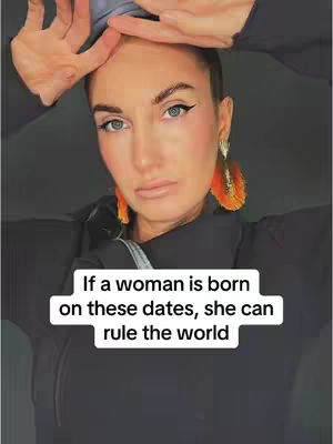 A woman with eye makeup and orange feather earrings looks down towards the camera as she holds both of her hands over her head with her palms facing towards her face. Text that reads, "If a woman is born on these dates, she can rule the world" is overlaid on the bottom of the image in a white box.