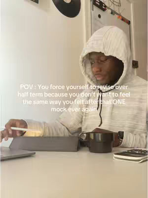 The cover image showcases a person, seemingly in a home office setting, with focus on studying materials. Visible elements include a laptop, a tablet, a cup of coffee, and a phone. The primary focus is on the person wearing a hoodie, and the text overlay describing a study-related scenario. The color palette is somewhat neutral, with off-white, light brown, and dark colors dominating the scene. The lighting appears natural, and the image is well-composed to indicate an everyday study session. The composition includes everyday studying items and adds a text, for an overview of the content.