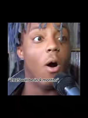 The cover image shows a close-up of a man with light skin, wearing blue-dyed hair, looking off to the side with wide eyes and mouth open in surprised expression. He is holding a microphone. A text overlay at the bottom reads, "2025 will be in 4 months."