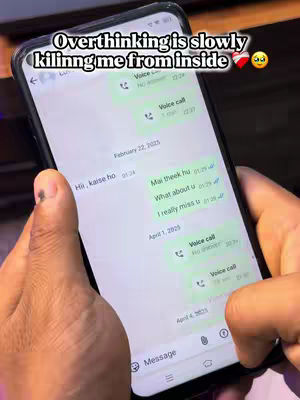 A close-up of a smartphone held in hands, displaying a messaging app. The screen shows a conversation with text bubbles and timestamps. Overlayed on top is text in a bubble form, which highlights the content of the video. The phone is black, and the background is blurred.