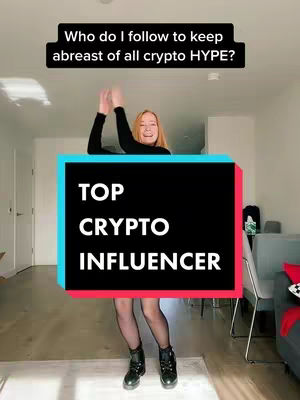 A woman with long blonde hair is standing in a room with a sign that says "TOP CRYPTO INFLUENCER". She is wearing a black outfit and boots. The image has a modern interior background with neutral colors.