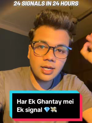 A selfie-style cover image featuring a young man with short, dark hair and glasses. The background appears to be a room with a ceiling fan visible at the top. The man is speaking directly to the camera, and there are two text overlays. The first, at the top, reads "24 Signals in 24 Hours" in a white, uppercase font. The second, located in a black and pink box at the bottom, says "Har Ek Ghantay mei Ek signal", followed by a diamond and a flower emoticon. The man's expression seems serious and engaged.