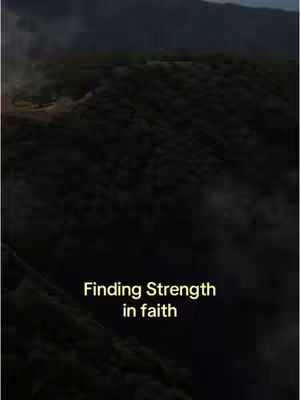A dark, vertical image depicting a landscape of hills and a visible text overlay towards the bottom center. The hills are covered in dark, dense foliage. The sky is obscured, with a gradient of light and dark shades suggesting overcast conditions. The text 'Finding Strength in faith' is in a simple, white sans-serif font. The overall mood is one of introspection or contemplation.