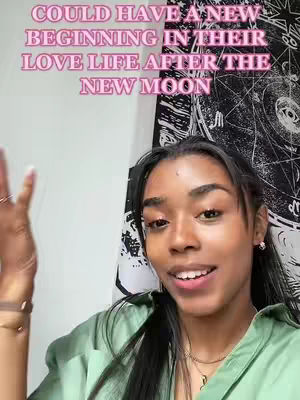 A young woman with long dark hair and a green shirt smiles at the camera. Text in a pink, outlined font overlays the top of the image: 'COULD HAVE A NEW BEGINNING IN THEIR LOVE LIFE AFTER THE NEW MOON'. The background includes a white wall and a patterned textile.