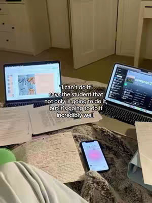 The image shows a study space with two laptops, papers, a cell phone, and crumpled blankets, arranged in what appears to be someone's bed. Text is overlaid, providing a motivational message.