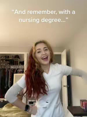 A woman with long reddish-brown hair, wearing a white scrub top is in a room with a closet, with what appears to be a mirror over it. The woman has a big, wide, happy grin and is mid-action with her arms out to her sides. Behind her is a messy closet.