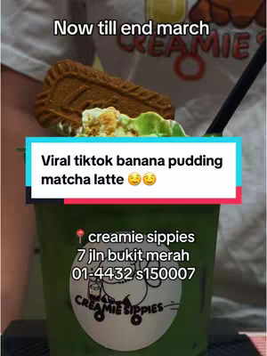 The image features a green drink in a clear cup, topped with matcha and a biscuit. Text overlays include the video title and cafe details against a background of a person's upper body wearing a white shirt.