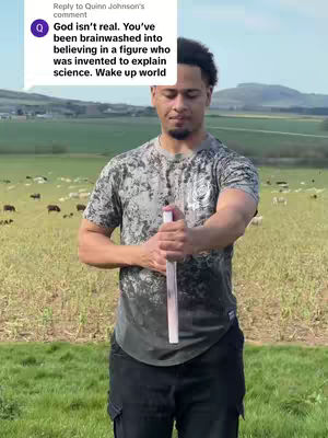 A man in a camo-printed t-shirt stands holding a vertical white pole in front of a grassy field, with a herd of cows grazing in the background; A comment from another user is overlain on the image.