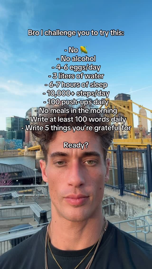 A man with short, dark hair and a serious expression stands against an outdoor urban background. Text overlays a list of challenges.