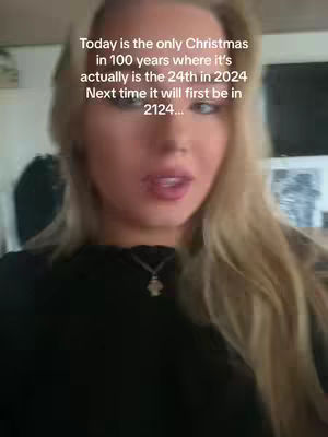 A selfie-style video cover image showing a young woman with long blonde hair. She is looking at the camera and speaking, with text overlaid. Behind her, the background is slightly blurred, showing a room with some decorations.