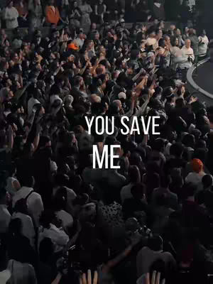 The cover image captures a large crowd of people in an indoor venue, likely a concert or church service, with many individuals raising their hands. The lighting is rather dark, and the color seems to be desaturated. The text overlay is in the middle of the image, in white and appears to be a part of worship and/or encouragement.