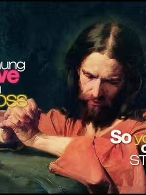The image presents a classic depiction of Jesus Christ. He is shown with long, dark hair and a beard, wearing traditional reddish-orange robes. His expression appears serious, as he holds a cross.