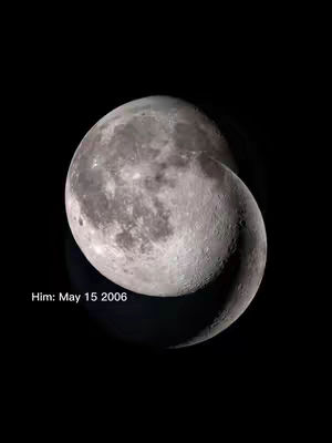 The image shows two overlapping crescent moon phases against a stark black background. One moon phase appears brighter, showcasing detailed surface features, while the other is a darker shadow, implying a cycle or transition. The text 'Him: May 15 2006' is present in the bottom left corner .