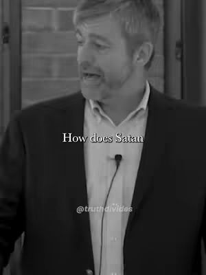 A black and white image with a man speaking during a presentation. He is wearing a button-down shirt and a suit jacket. Text overlays read 'How does Satan' and '@truthdivides'.