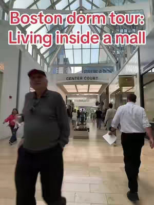 The cover image shows a man walking through a mall corridor with a sign that reads "Center Court." The image is brightly lit, with a glass ceiling visible, and other people are walking in the background.