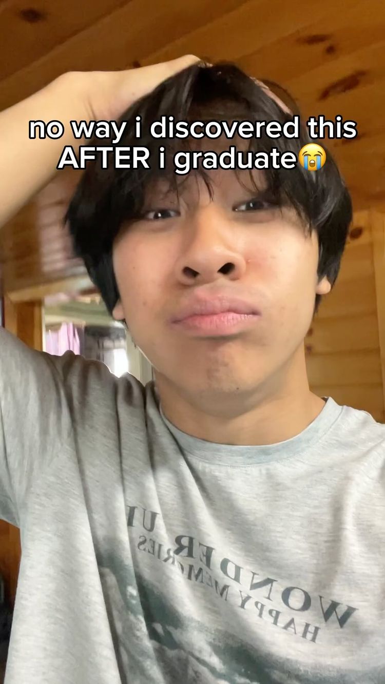 A selfie-style shot of a young man looking up with a concerned expression, his hand touching his head. Text overlayed on the image reads, \"no way i discovered this AFTER i graduate\", which indicates a possible reaction to some information.